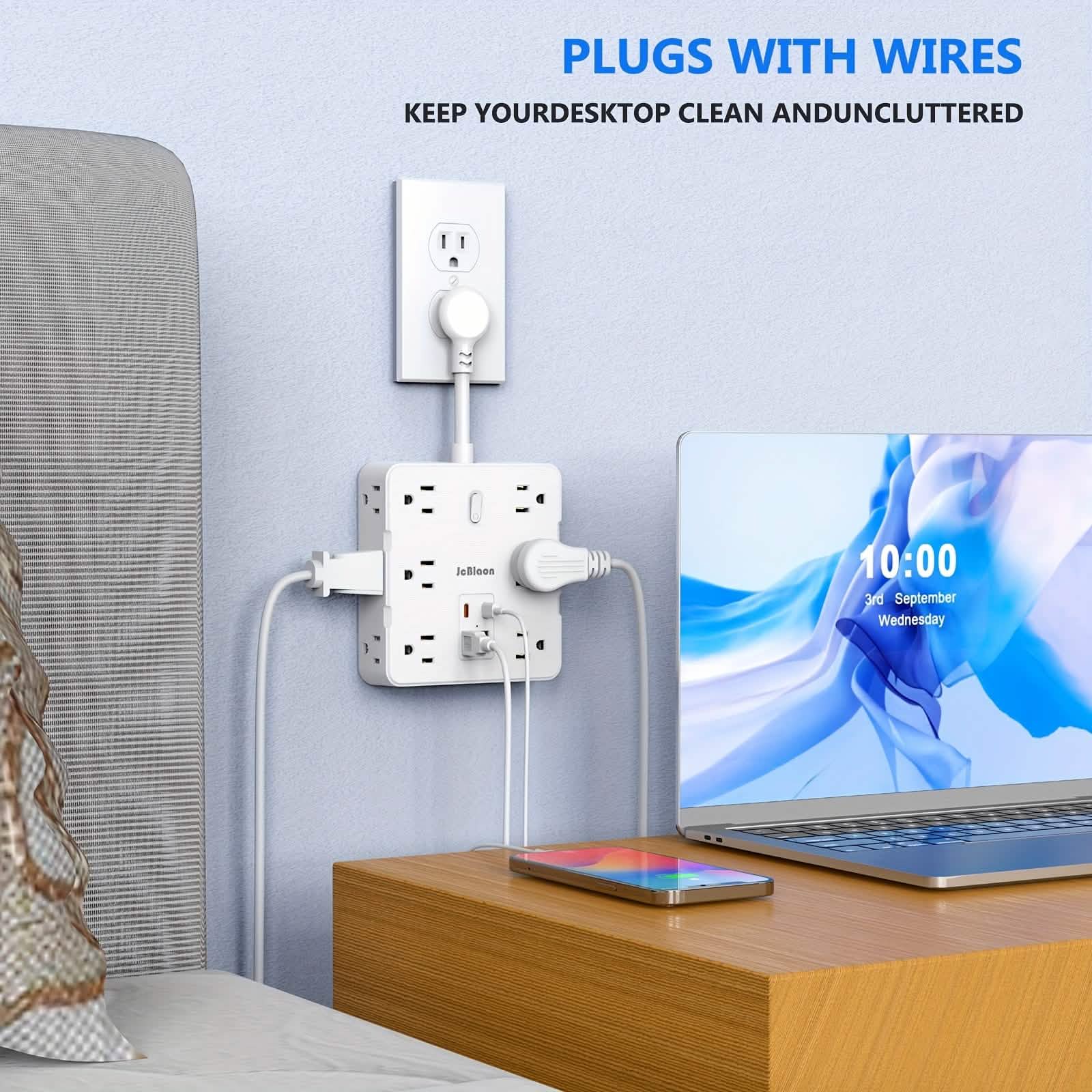 Bedroom scene with a power strip, plugs, and a laptop on a desk.