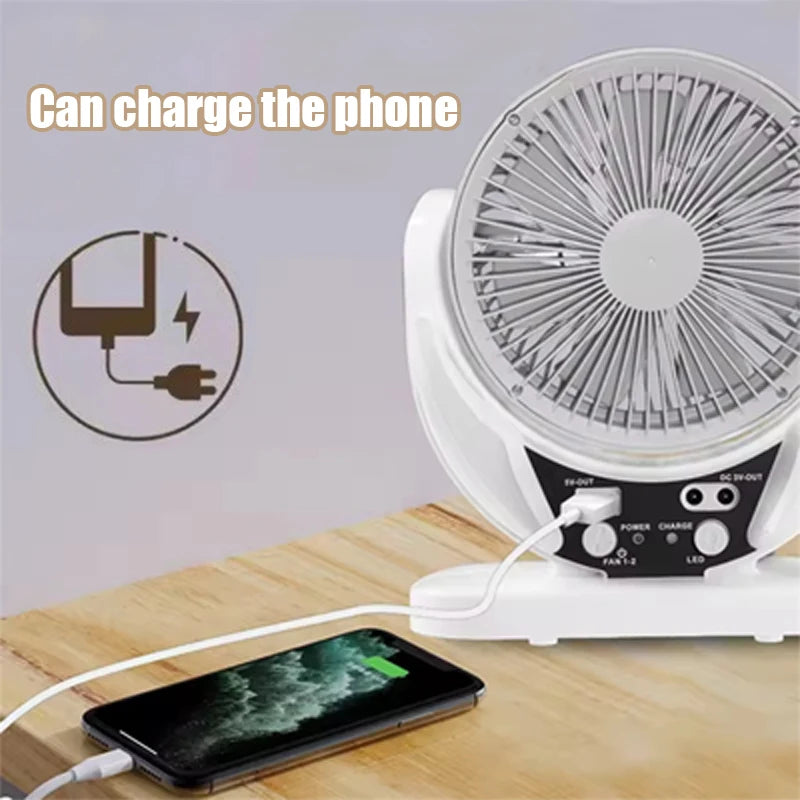 Fan with phone charging cable on a wooden surface, text 'Can charge the phone' above.