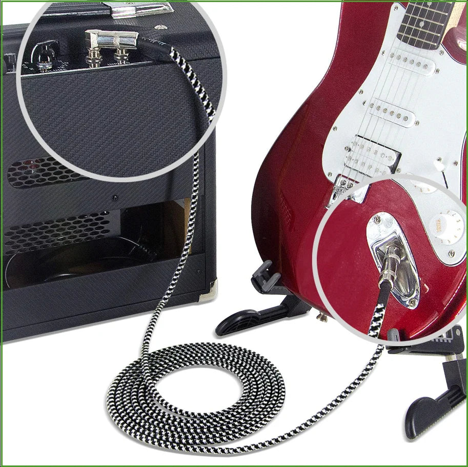 Guitar amplifier with a cable connected to a red electric guitar on a white background