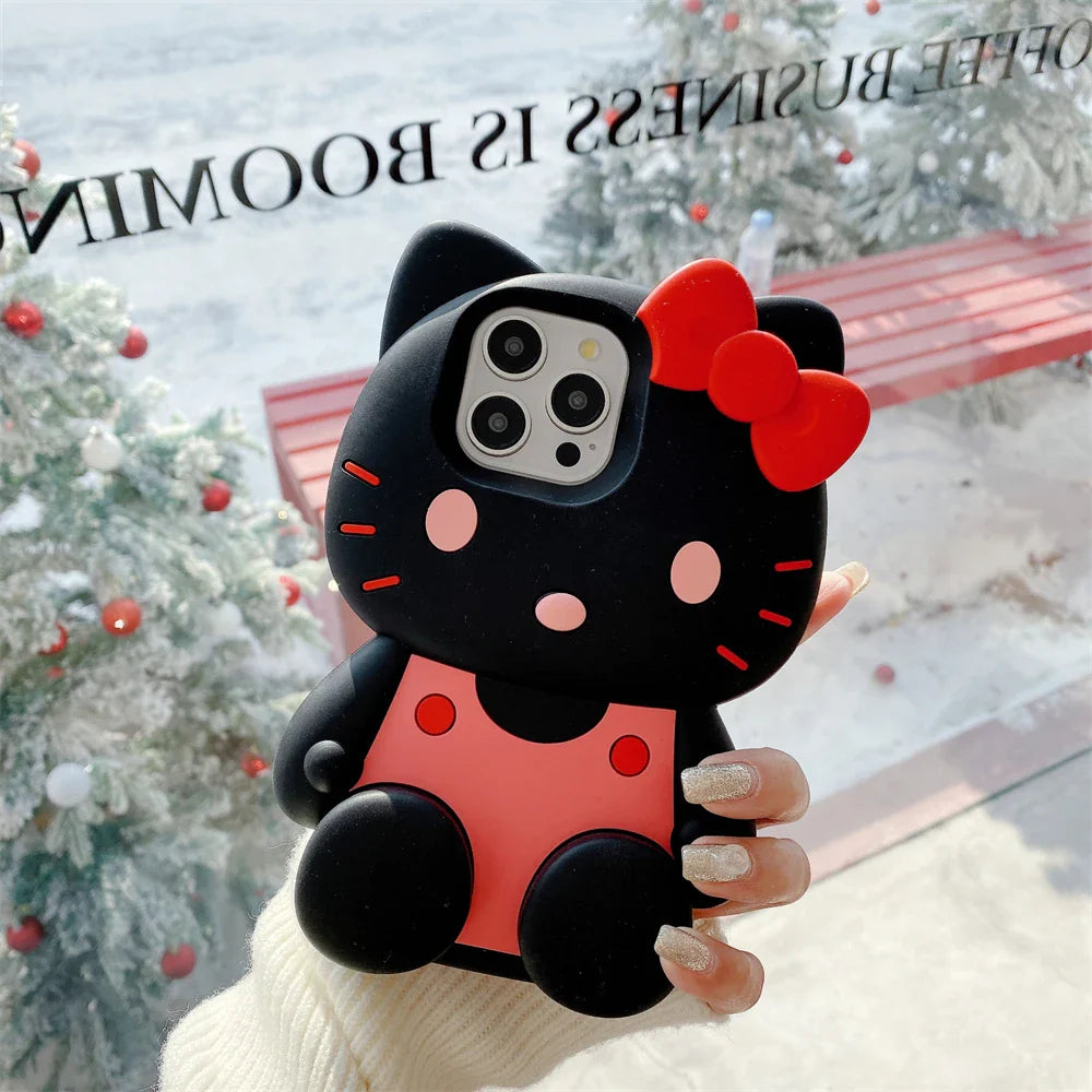 Black and red phone case with a bow held by a hand in front of a Christmas tree.