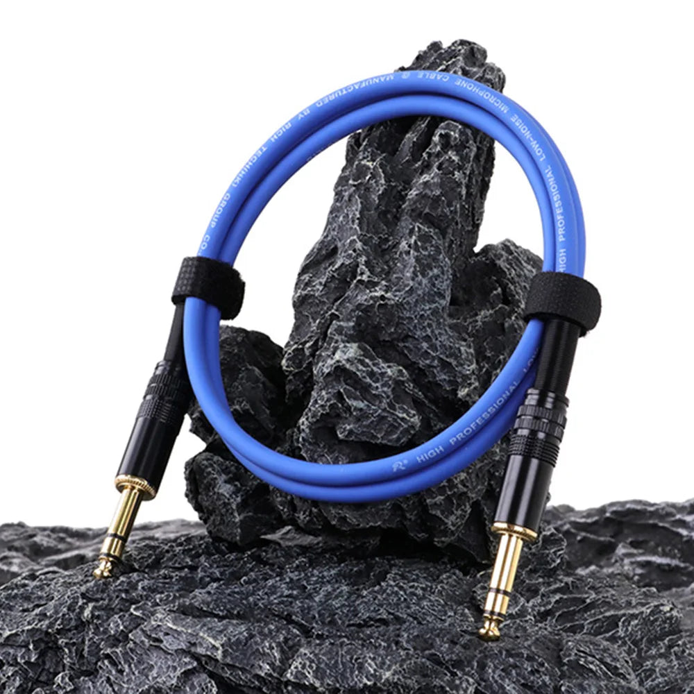 Blue audio cable coiled on a rock with a white background