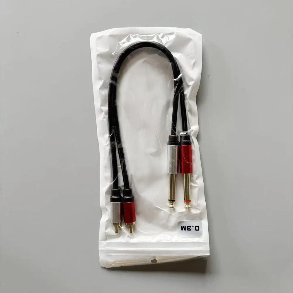 Audio cable with red and black plugs in a clear plastic bag on a gray background