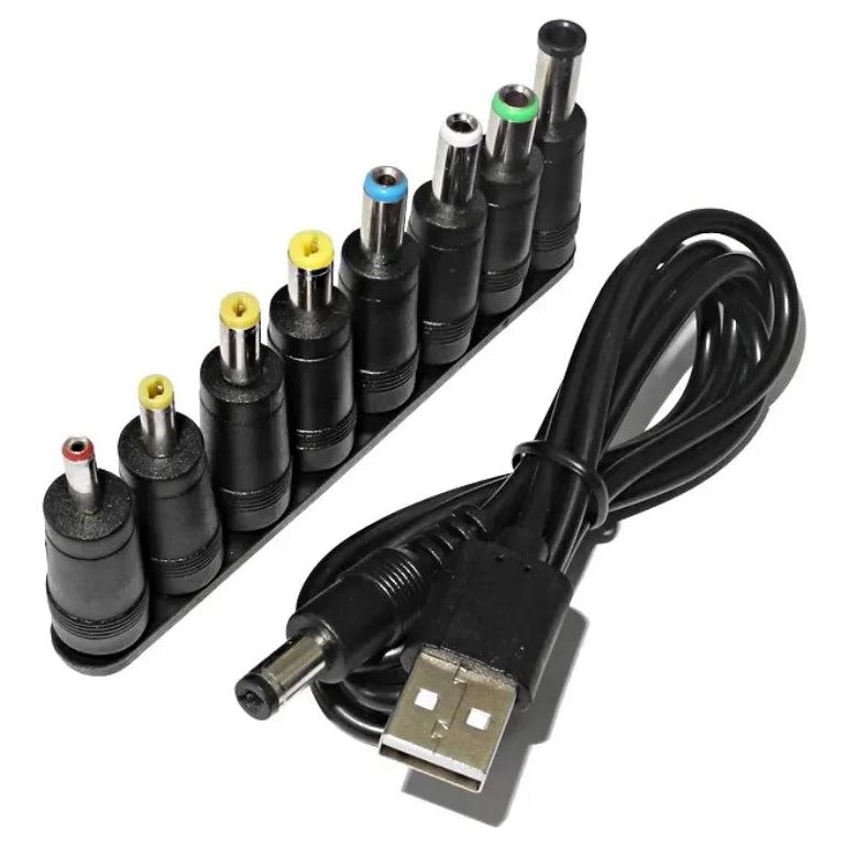 Set of various computer power adapter plugs with a USB cable on a white background