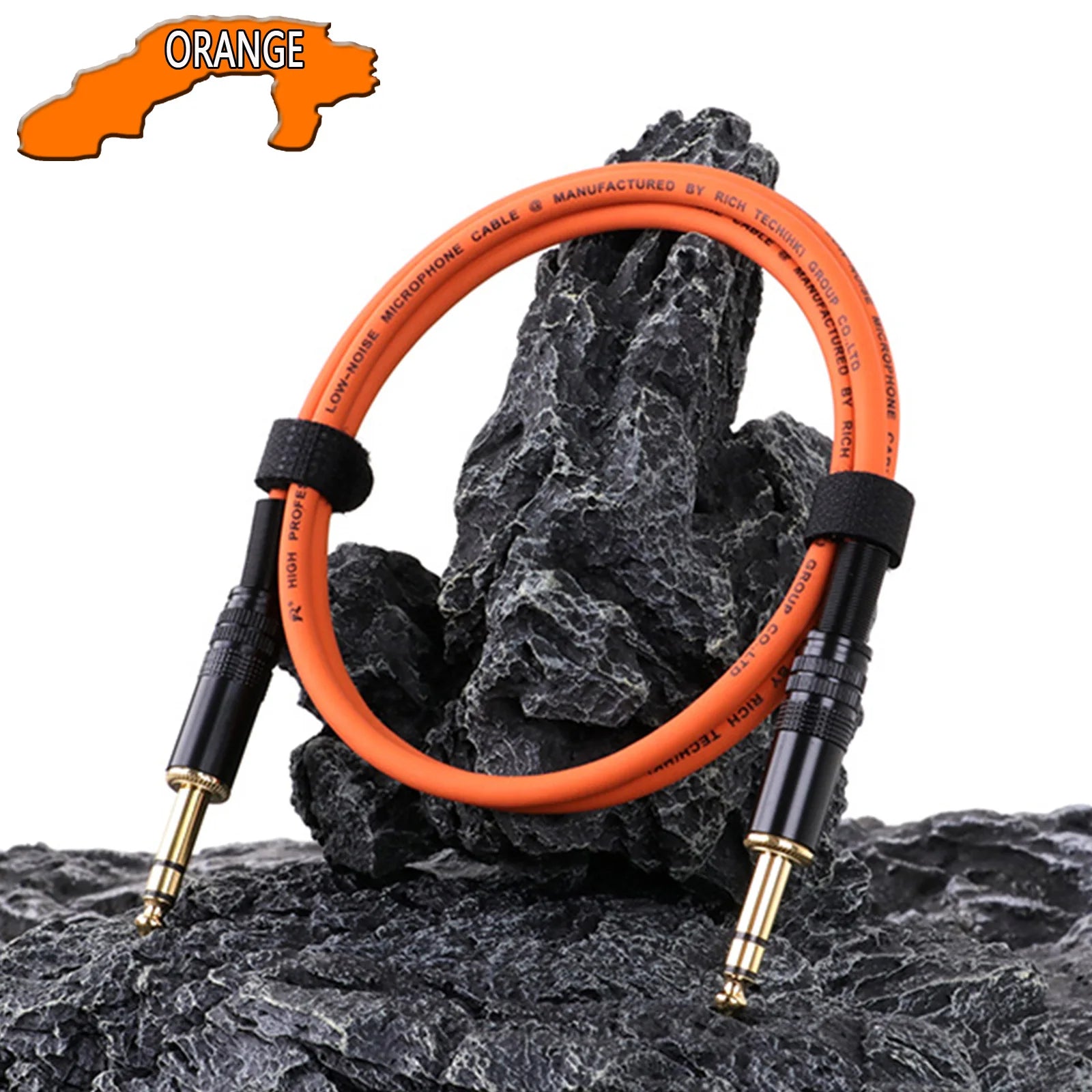 Orange audio cable on a rocky surface with 'Orange' branding.