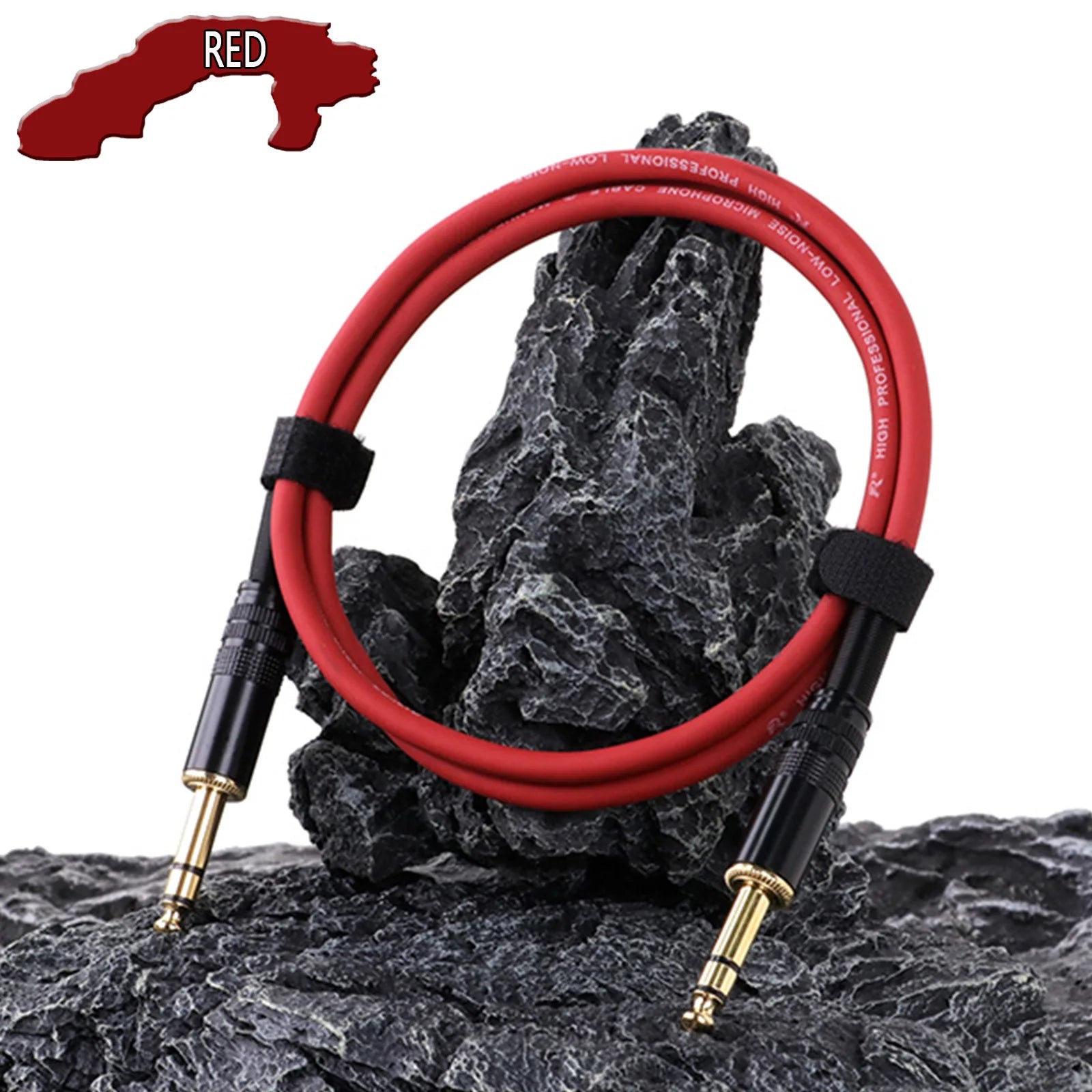 RED audio cable with black connectors on a rocky surface