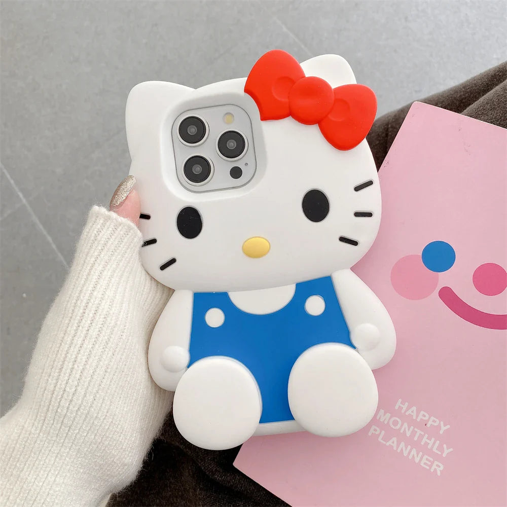Phone case shaped like a cartoon cat with a red bow, held by a person wearing a white sleeve.