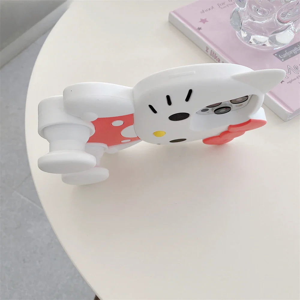 White cat-shaped phone holder on a white surface with a blurred background
