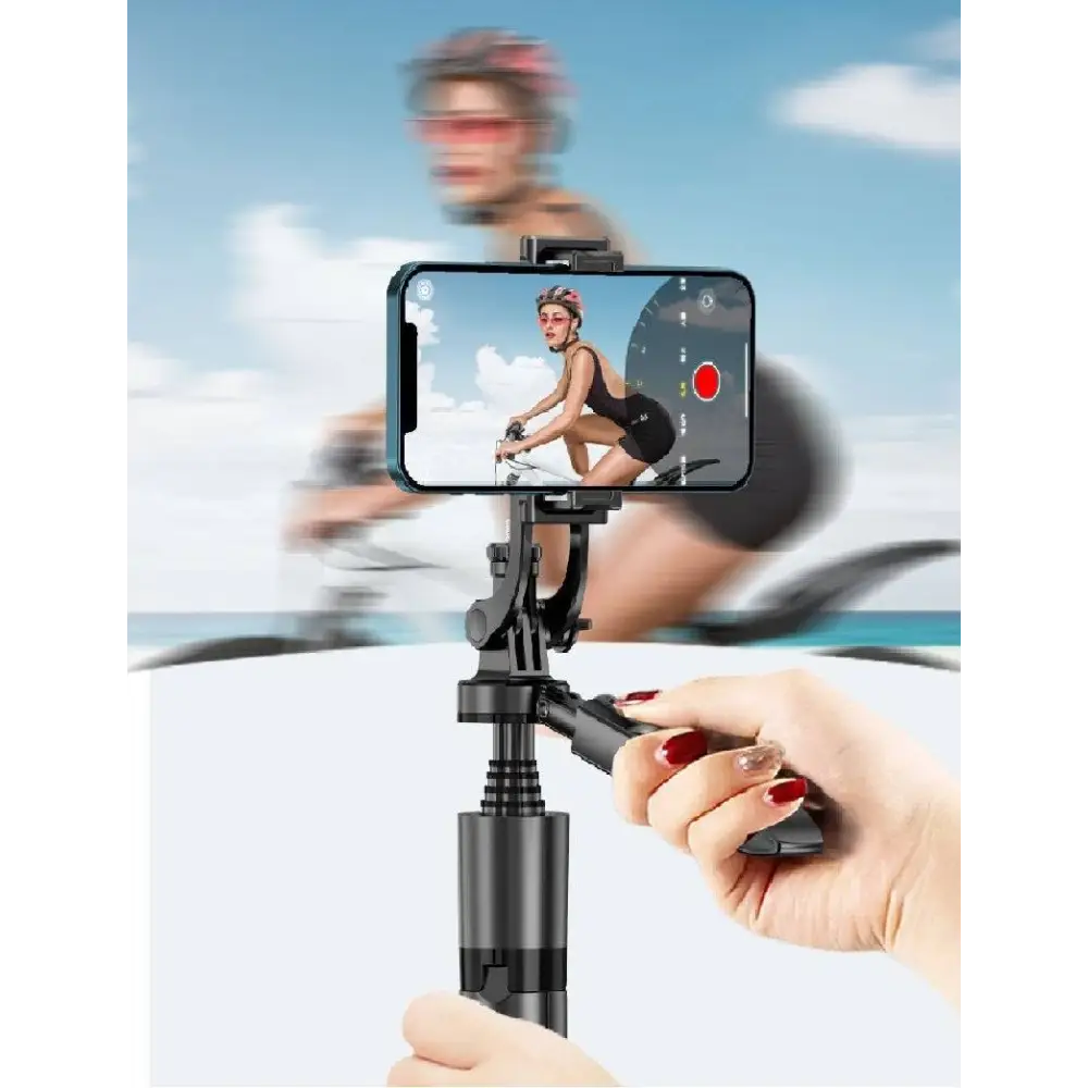 Hand holding a smartphone with a gimbal stabilizer against a blurred background of a cyclist.