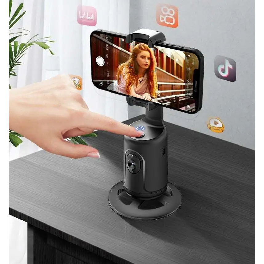 Hand using a smartphone with a gimbal on a table, with app icons displayed.